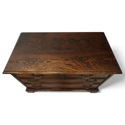T & G style solid oak television cabinet, rectangular moulded top over two short and two long drawers with brass swing handles, the upper frieze drawer front hinged and fitted with stay to reveal pull-out shelf, open compartment above with circular cable aperture to rear, on bracket feet
