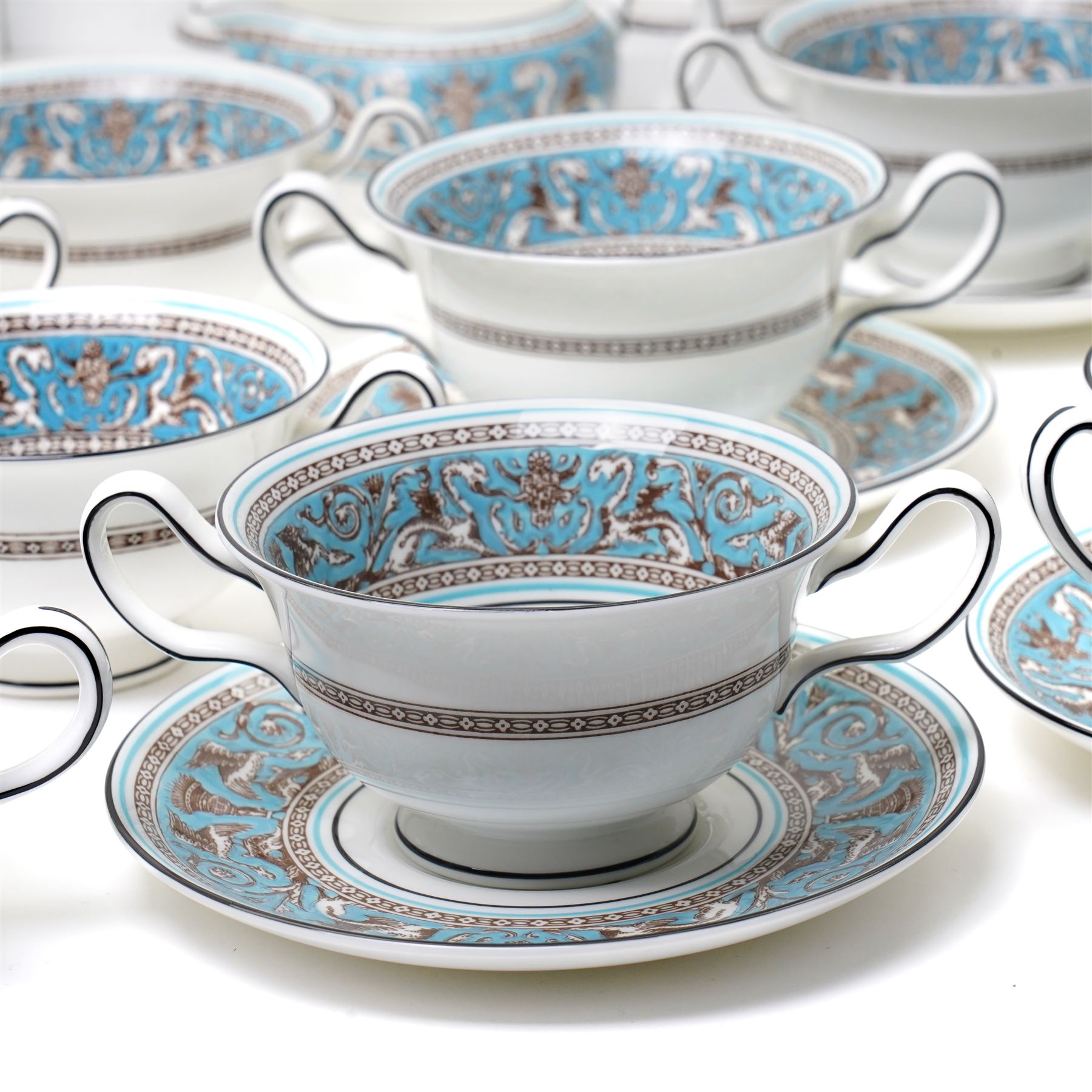 Wedgwood turquoise Florentine part service, comprising large covered tureen and stand, coffee pot, teapot, two covered sucriers, milk jug, two sauce boats and stands, seven soup plates, three bowls, jug, eighteen soup bowls and fifteen stands, two ashtrays, thirteen further saucers, twelve teacups and eleven saucers, and twenty-one further plates of varying sizes
