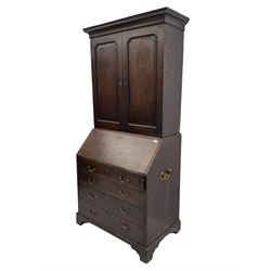George III walnut bookcase on bureau, dentil cornice over two panelled doors, fall front bureau with fitted interior and four long graduating drawers, on bracket feet 