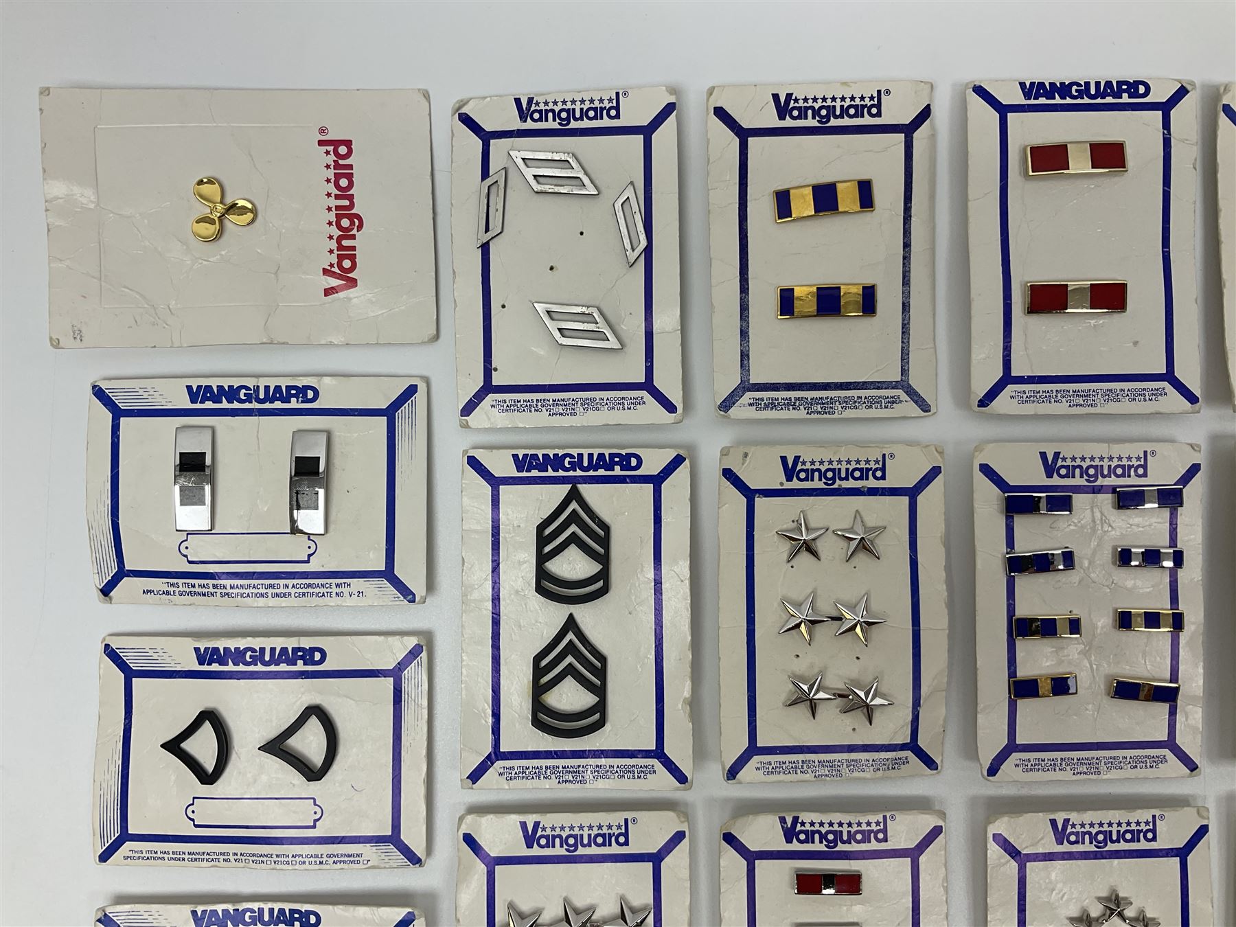 Fifty US rank badges and trade badges; WW2 and Vietnam period; predominantly on sale cards