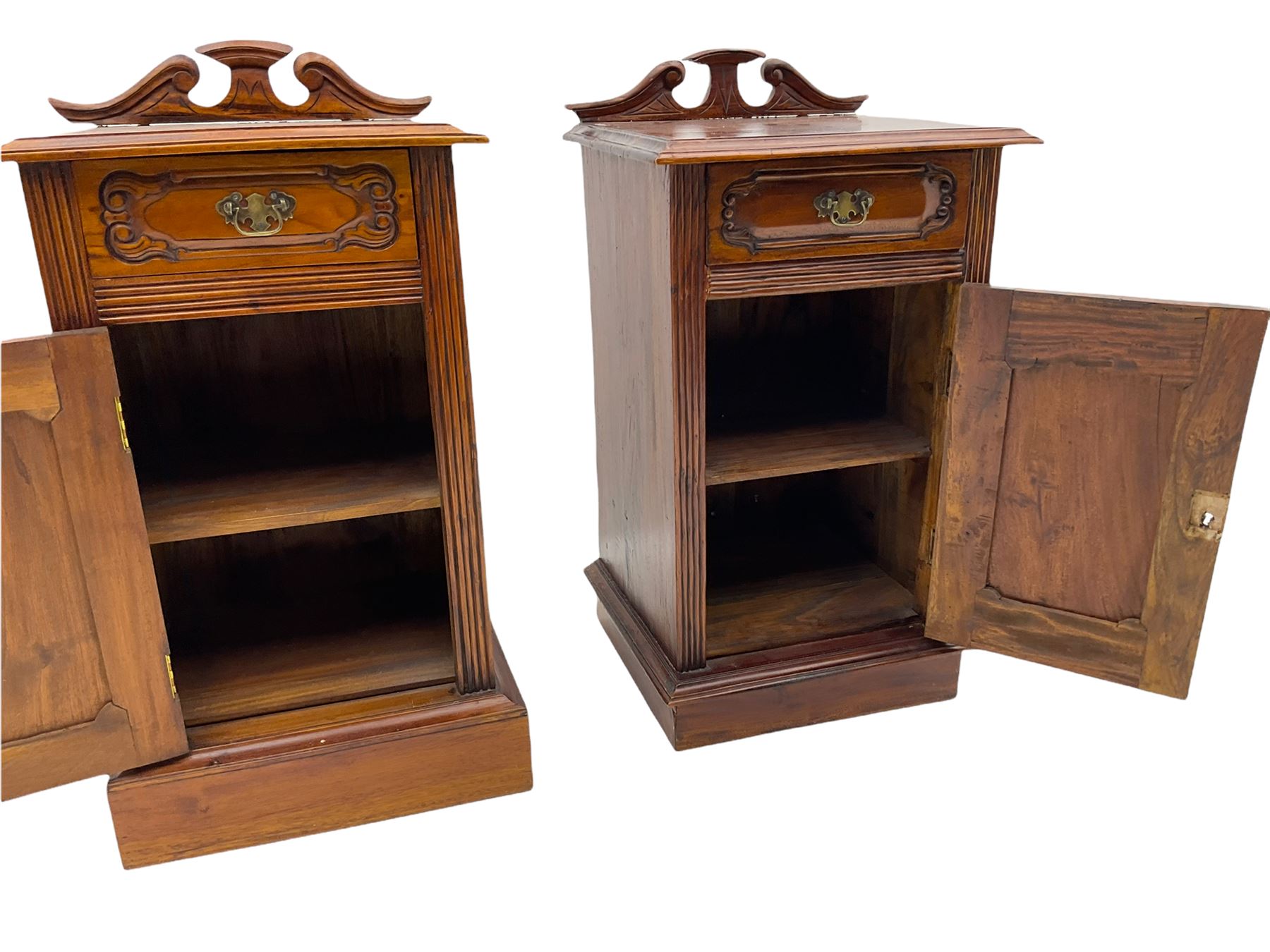 Pair Victorian style hardwood bedside cabinets, fitted with single drawer and cupboard, the doors carved with floral urns, on plinth bases