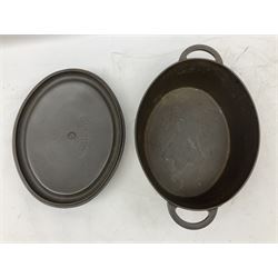 Emile Henry covered casserole dish of oval form in two tone brown and cream, no. 03.06, together with cast iron Nomar twin handled lidded casserole dish of oval form in navy, and other ovenware including Flintware ICTC, largest L35cm