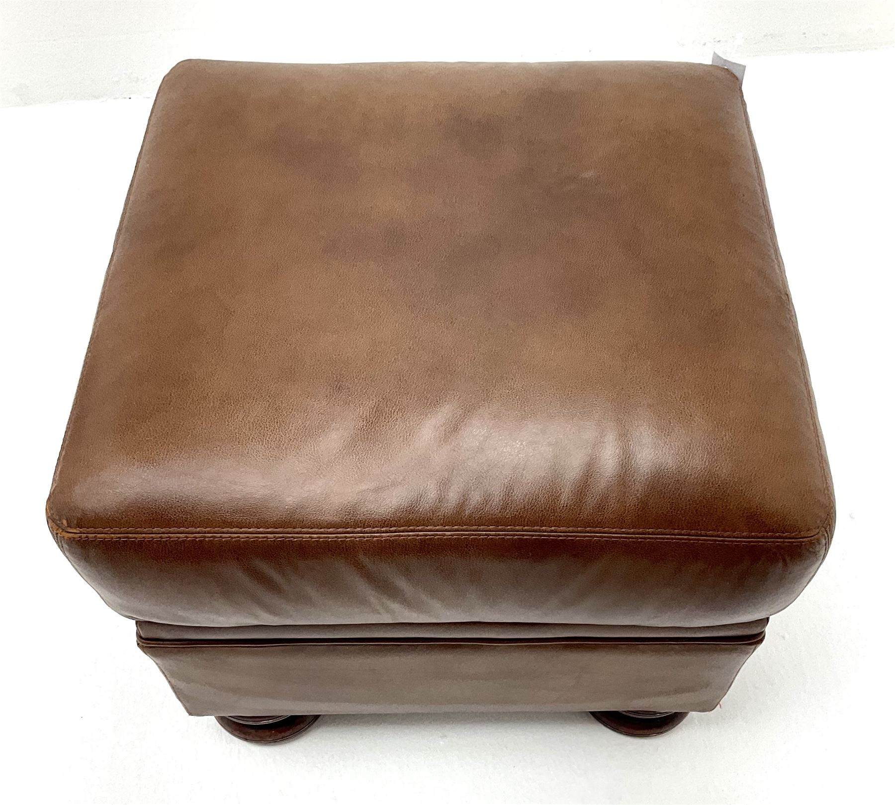 Three seat studded tan leather sofa, scrolling arms, turned supports (W190cm) with matching two seat (W155cm) armchair (W100cm) and footstool 