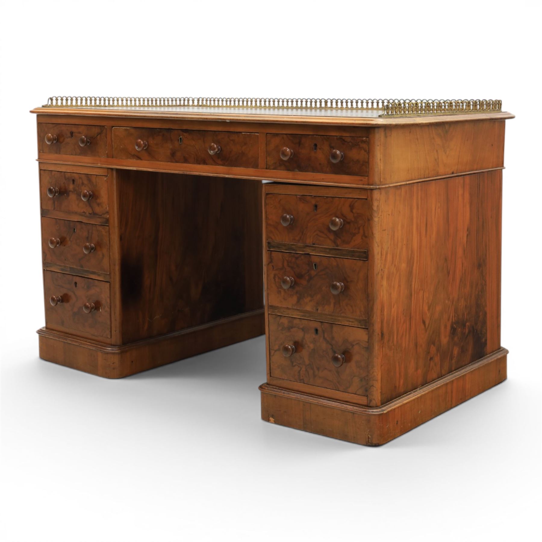 Victorian figured walnut twin pedestal desk, brass galleried top with inset tooled green leather writing surface, above three frieze drawers, raised on two pedestals with three drawers, on plinth bases above castors