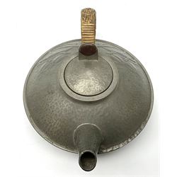 Archibald Knox for Liberty & Co Tudric pewter three piece tea service, comprising teapot with woven reed handle, single handled open sucrier, and milk jug, each with planished finish and detailed with honesty flowers, each impressed beneath Made in England Tudri Pewter 0231 