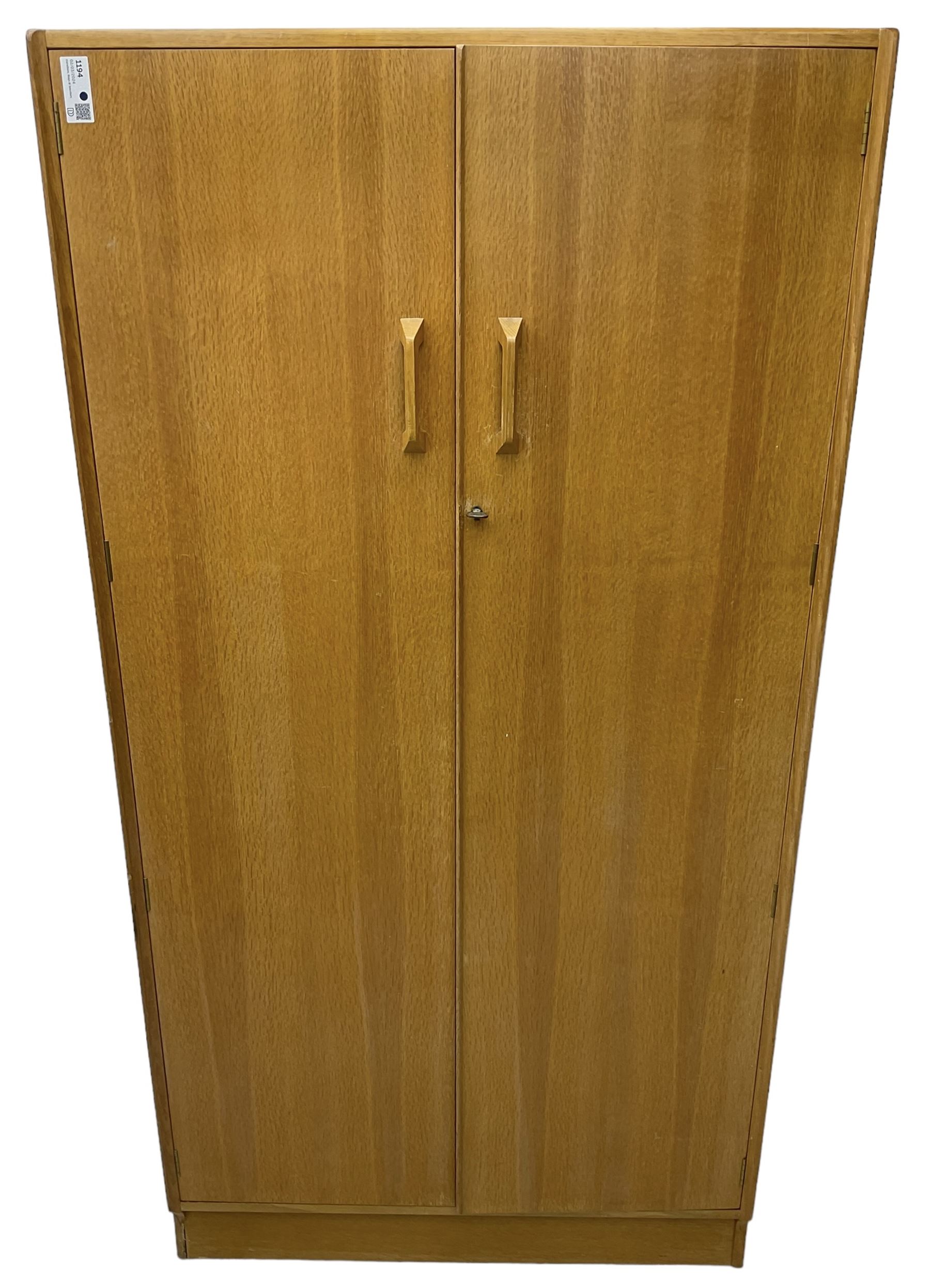 E. Gomme for G-Plan - 'Brandon' light oak double wardrobe, the interior fitted with hanging rail and shelves 