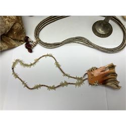 Collection of traditional necklaces from the Solomon Islands, including shell and boar tusk examples, together with a carved canoe prow, with mother of pearl eyes, painted cow hide and a copper plaque, depicting the Solomon Islands, with presentation engraving