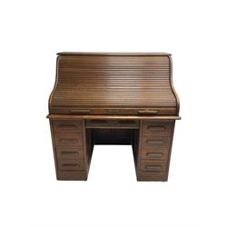 Early 20th century oak twin pedestal roll top desk, the tambour roll enclosing fitted interior, fitted with six drawers and two sides