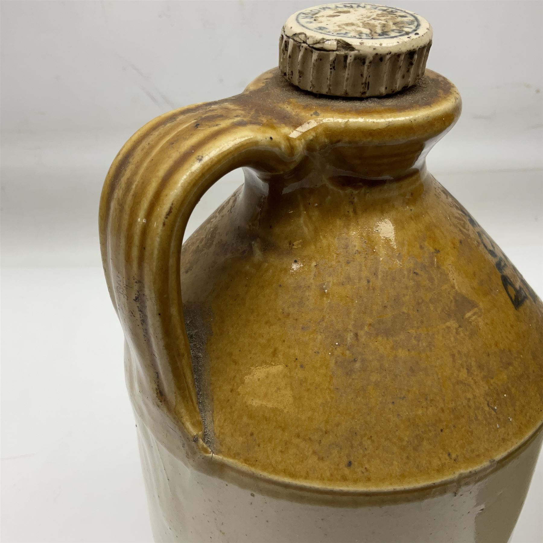 Early 20th century stoneware advertising flagon, marked to front 'Pickup Bros Botanical Brewers', together with a larger stoneware flagon