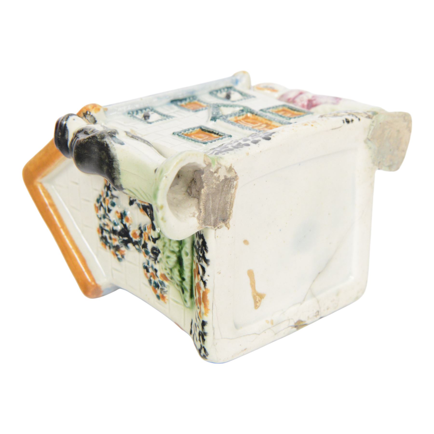 19th Century Staffordshire pearlware Prattware type money box, modelled as a houe with two figures to the front corners, H13cm