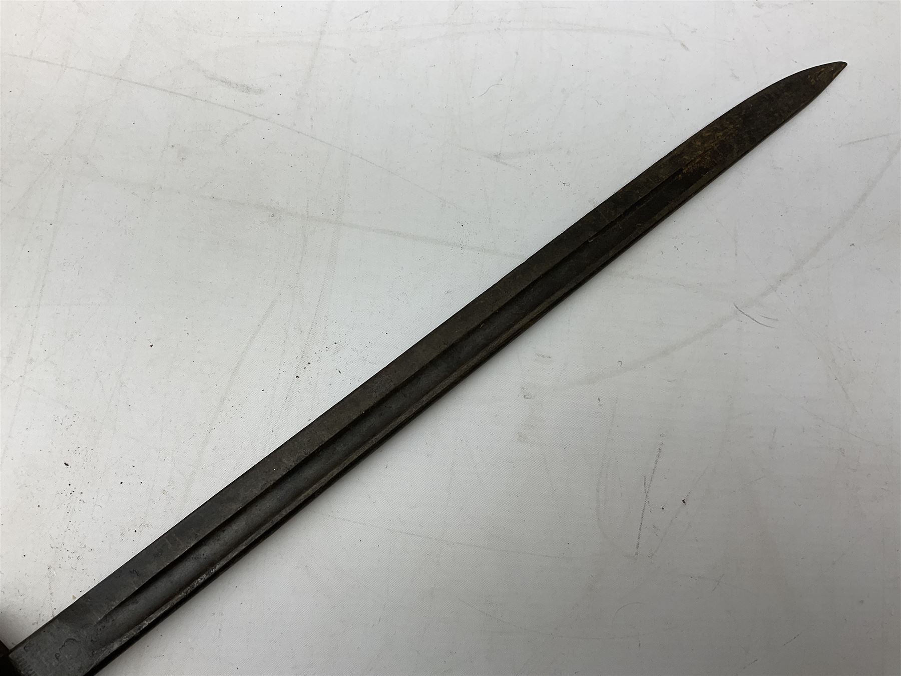 British Pattern 1907 bayonet with 43.5cm fullered steel blade; in leather scabbard with webbing frog L58cm overall; another Pattern 1907 bayonet lacking scabbard; and British Pattern 1888 Mk.I bayonet by Wilkinson London (no scabbard) (3)