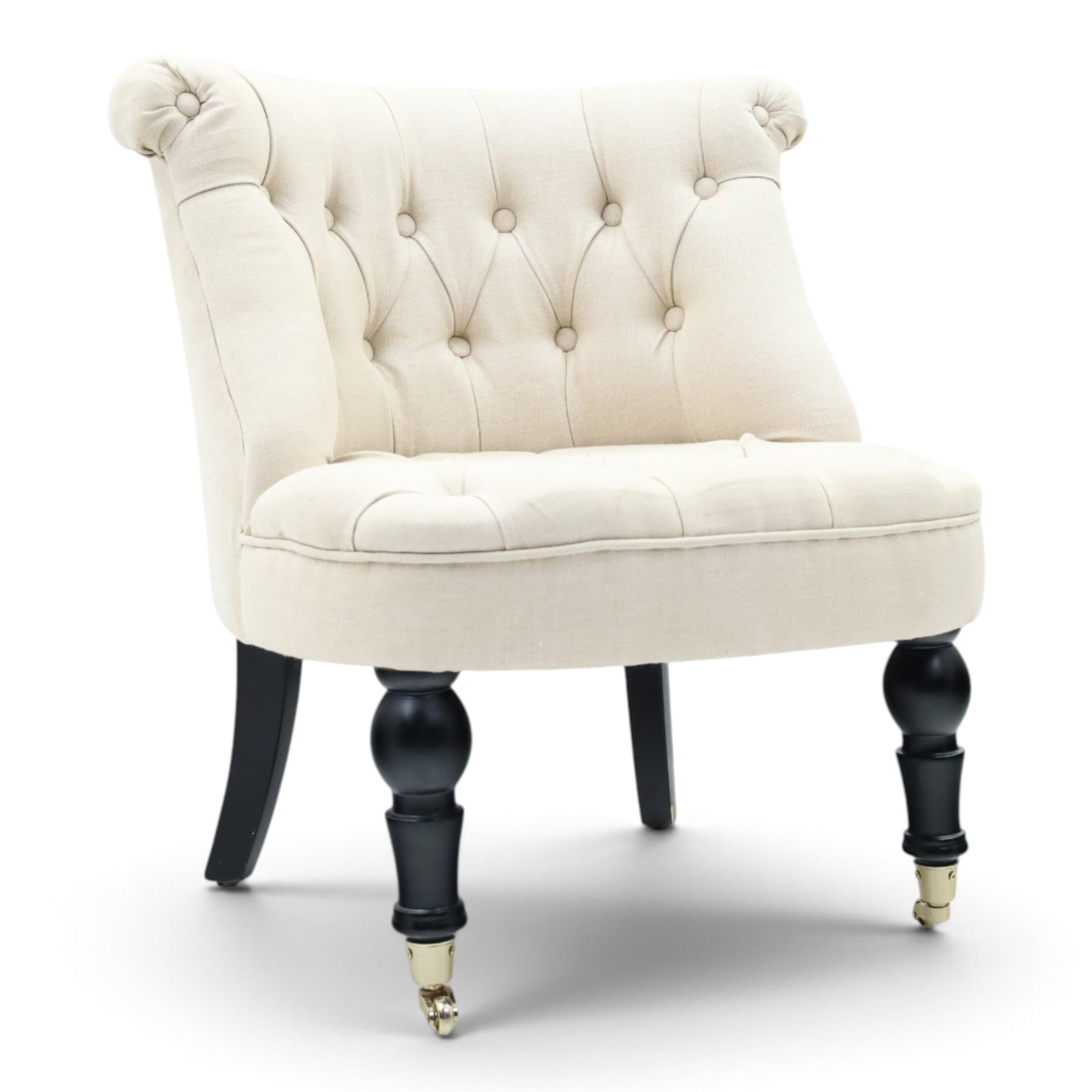 Victorian style upholstered tub chair, buttoned cream fabric back and seat with rolled sides, on ebonised turned front supports with brass castors and splayed rear supports