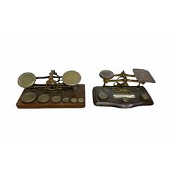 Two sets of 19th/ early 20th century brass postal scales with weights, one  with plaque displaying inland letter rates, L195cm max (2)