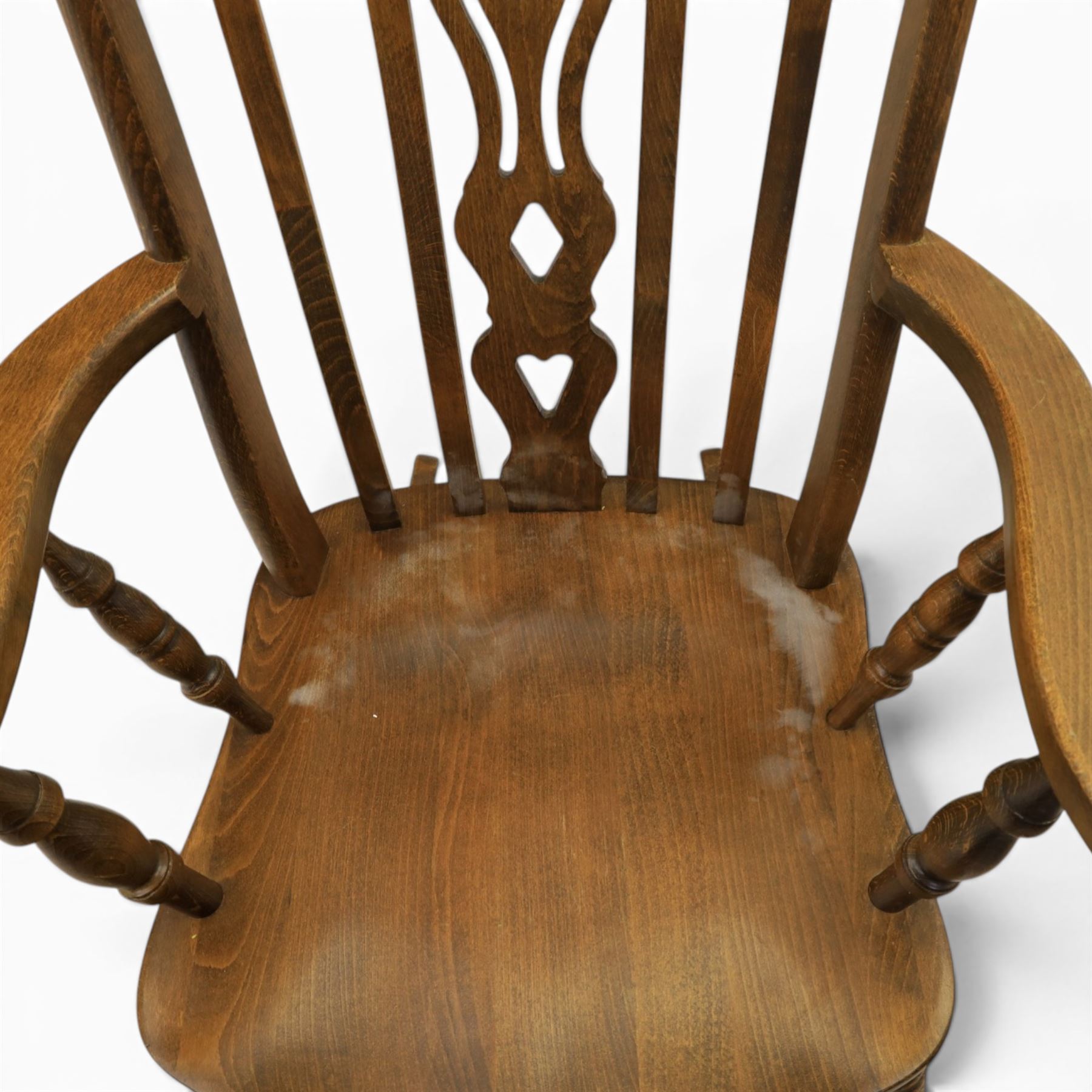 Farmhouse elm rocking chair, high back with 'Fleur De Lis' splat, shaped arms above turned supports, on rocker base 