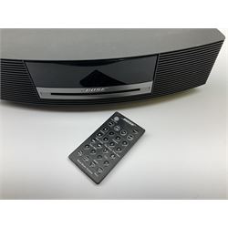 A Bose Wave music system, model AWRCC5, with remote control. 