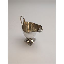 1920s silver cream jug, of helmet form with loop handle and upon a square base, hallmarked Charles Edwards, London 1926, including handle H15cm
