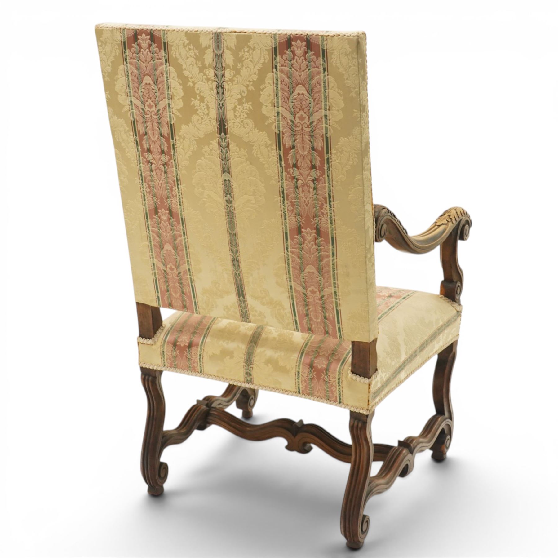 Pair of French Louis XIV design carved walnut open throne armchairs, high back and sprung seat upholstered in foliate damask fabric, acanthus carved scroll form arms over reeded and scrolled supports united by shaped stretcher