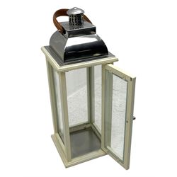 Contemporary painted wooden wine cabinet, rectangular form with carved leaf moulded cornice over single drawer and fifteen bottle compartments, flanked by spiral twist pilasters; together with a cream painted and chrome lantern, with glazed sides and leather handle (2)