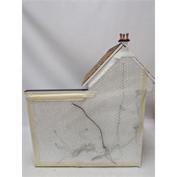 1:24 scale four-storey tudor-style dolls house, with black and white exterior, balcony garden, glazed panelled windows and wooden shingle roof, with decorated interior and wired fireplaces and lighting, H65cm, W58cm, D31cm, 