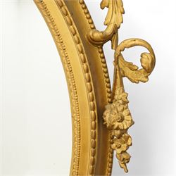 Late 19th century Louis XVI style giltwood and gesso girandole oval wall mirror, the oval frame surmounted with stylized urn finial and ribbon-tied garlands, laurel swags and rosettes, egg and dart decorated inner moulding and linked acorn outer moulding, flanked by intertwined foliate decorated candle branches 