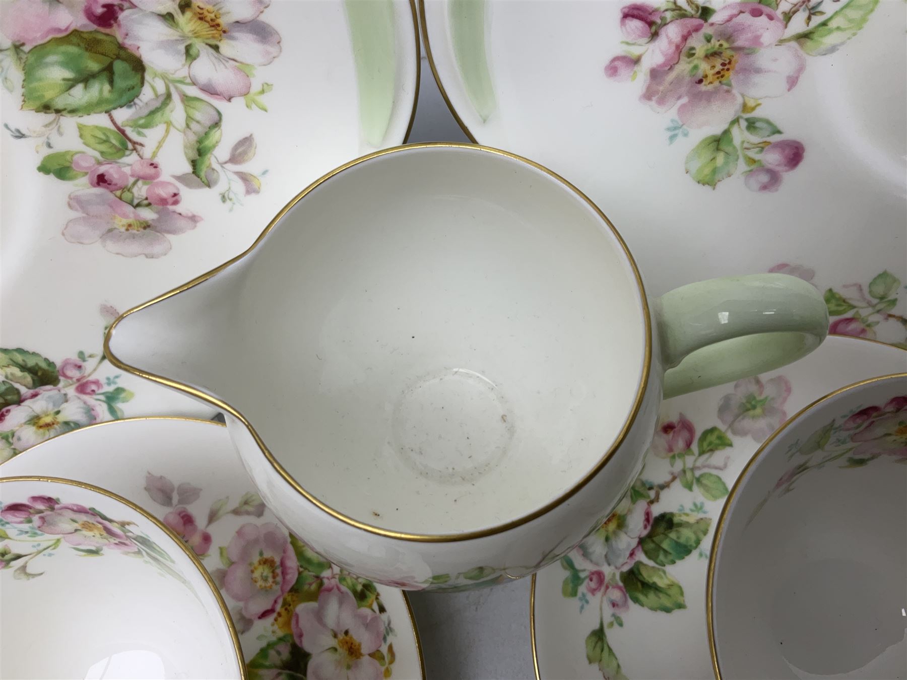 Royal Doulton Apple Blossom pattern tea service for twelve, comprising twelve saucers, twelve tea plates, twelve teacups, milk jug, sucrier and two cake plates