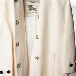 Burberry London - wool coat in cream, with concealed front popper fastening, bracelet-length sleeves with tab and black button detail and side slip pockets, with slit to back, size 40, unused with original Harvey Nichols garment bag and hanger
