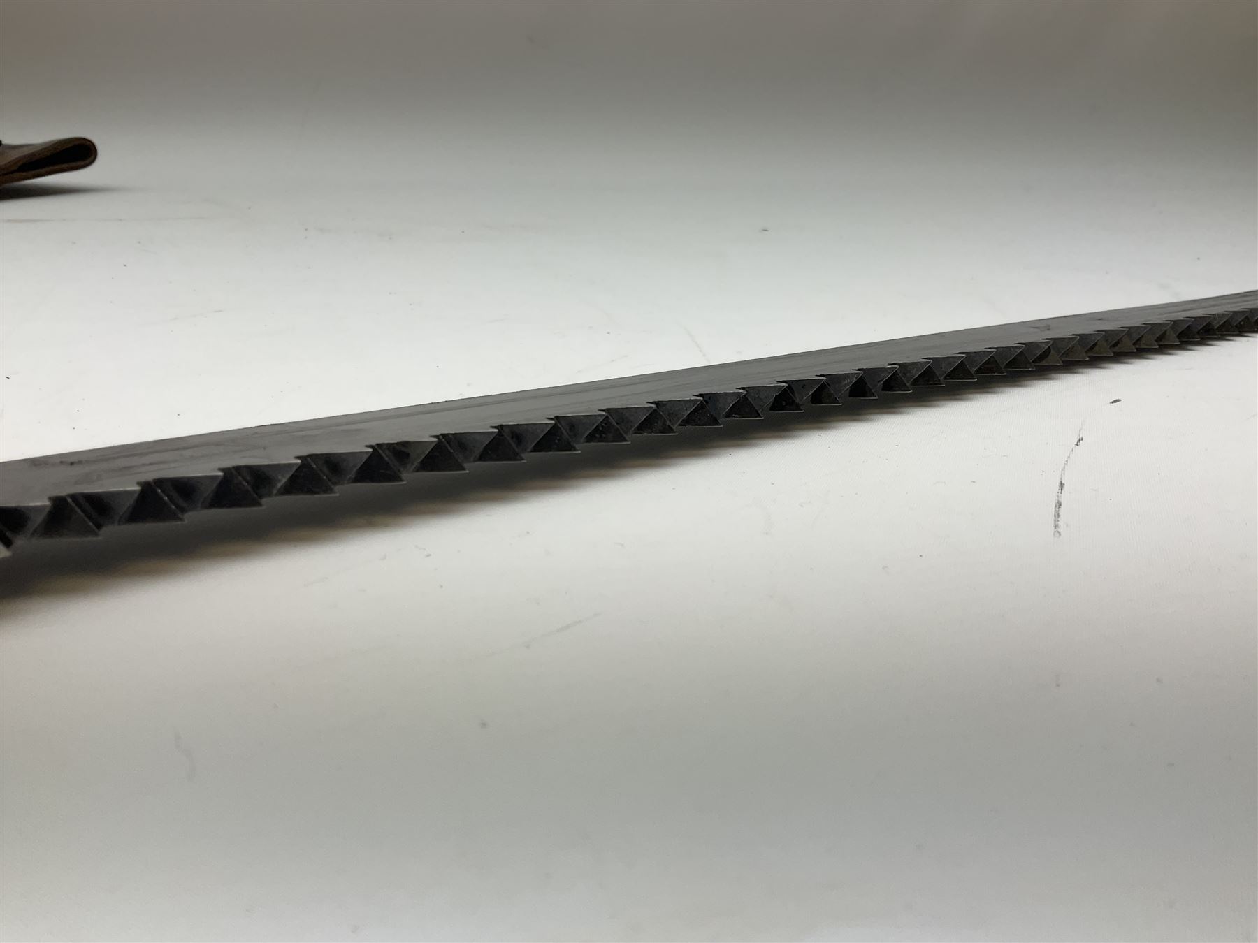 Swiss Schmidt-Rubin M1914 pioneer bayonet, with 48cm steel saw-back blade, the ricasso stamped, ''Waffenfabrik, Neuhausen'', the crosspiece stamped Swiss cross, steel scabbard, leather frog L64cm overall