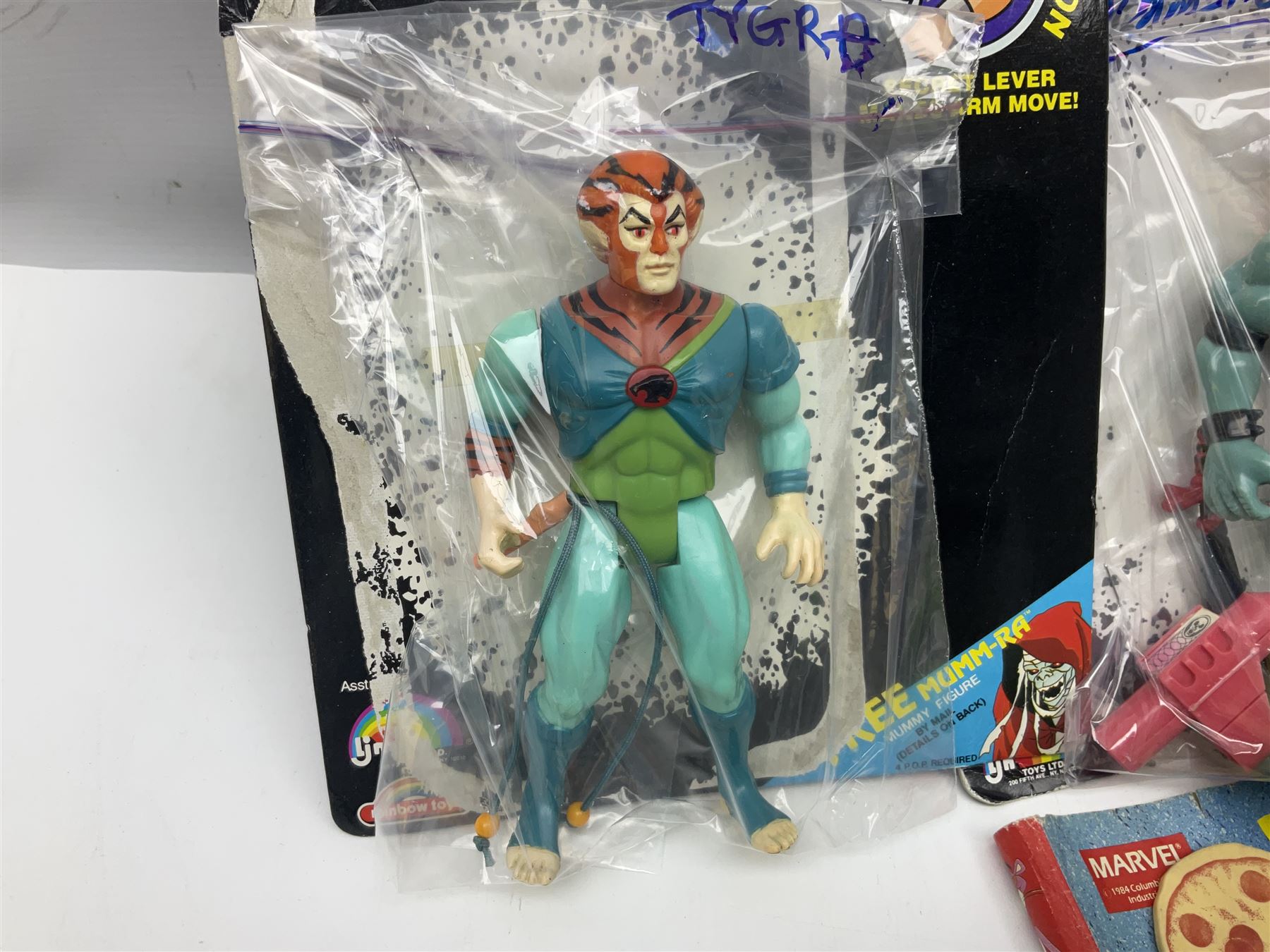 Five 1980s LJN Thundercats figures - Lion-O with sword, Snowman, S-S-Slythe, Tygra and Mumm-Ra; all re-bagged on original backing cards; partially stocked Panini sticker album; story cassette tape and three catalogues; together with Ghostbusters Slimer with food and Comic