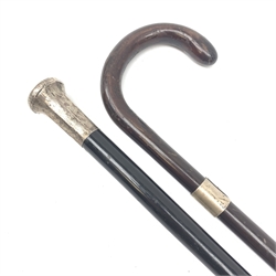 A silver mounted ebonised walking cane, the foliate engraved silver top hallmarked London 1923, maker's mark worn and indistinct, together with a further silver mounted cane, hallmarked London 1923, maker's mark worn and indistinct. 