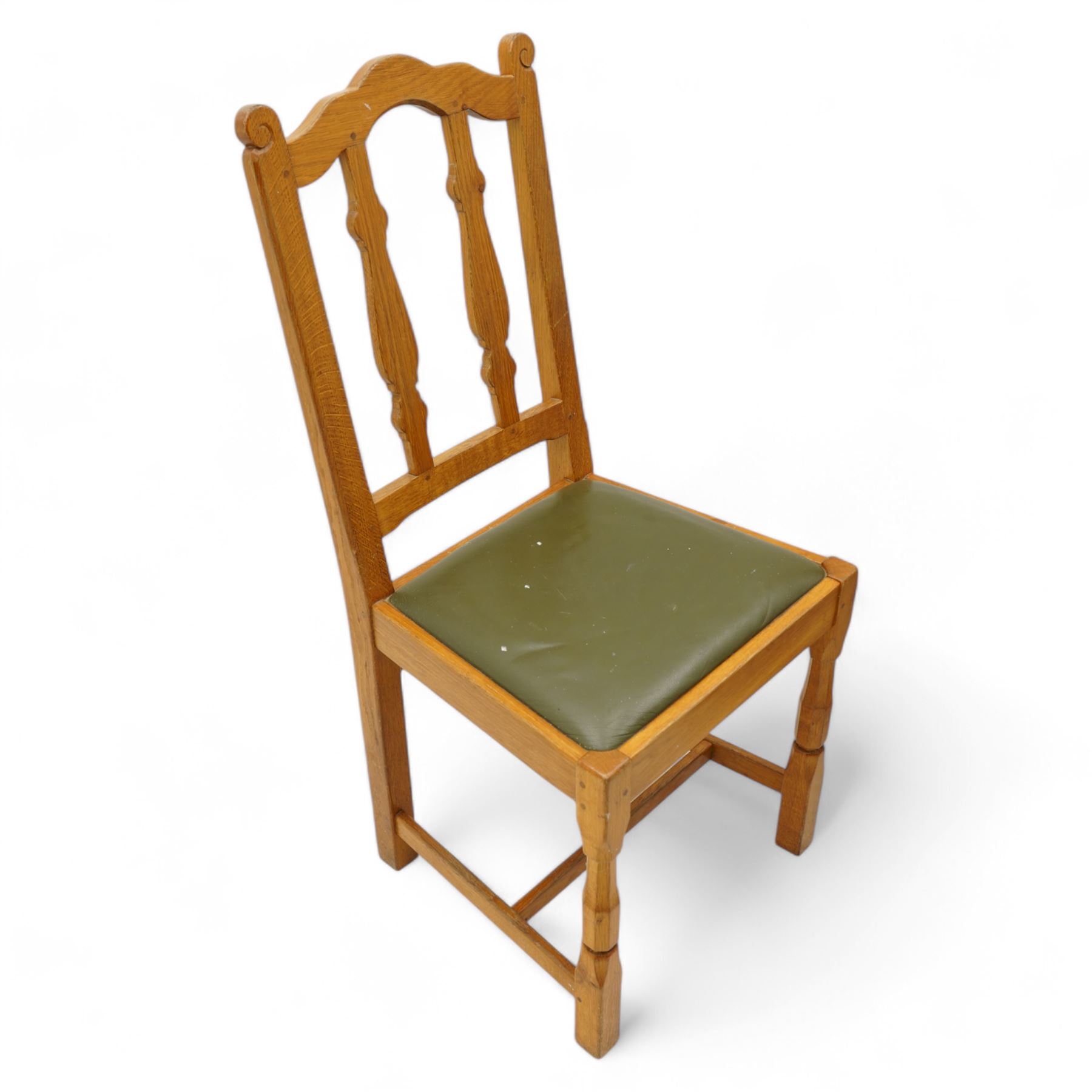 Beaverman - set of four oak dining chairs, shaped cresting rail over two shaped vertical rails, green leather upholstered drop-in seats, on octagonal supports united by plain stretchers, each carved with beaver signature, by Colin Almack, Sutton-under-Whitestone Cliffe, Thirsk