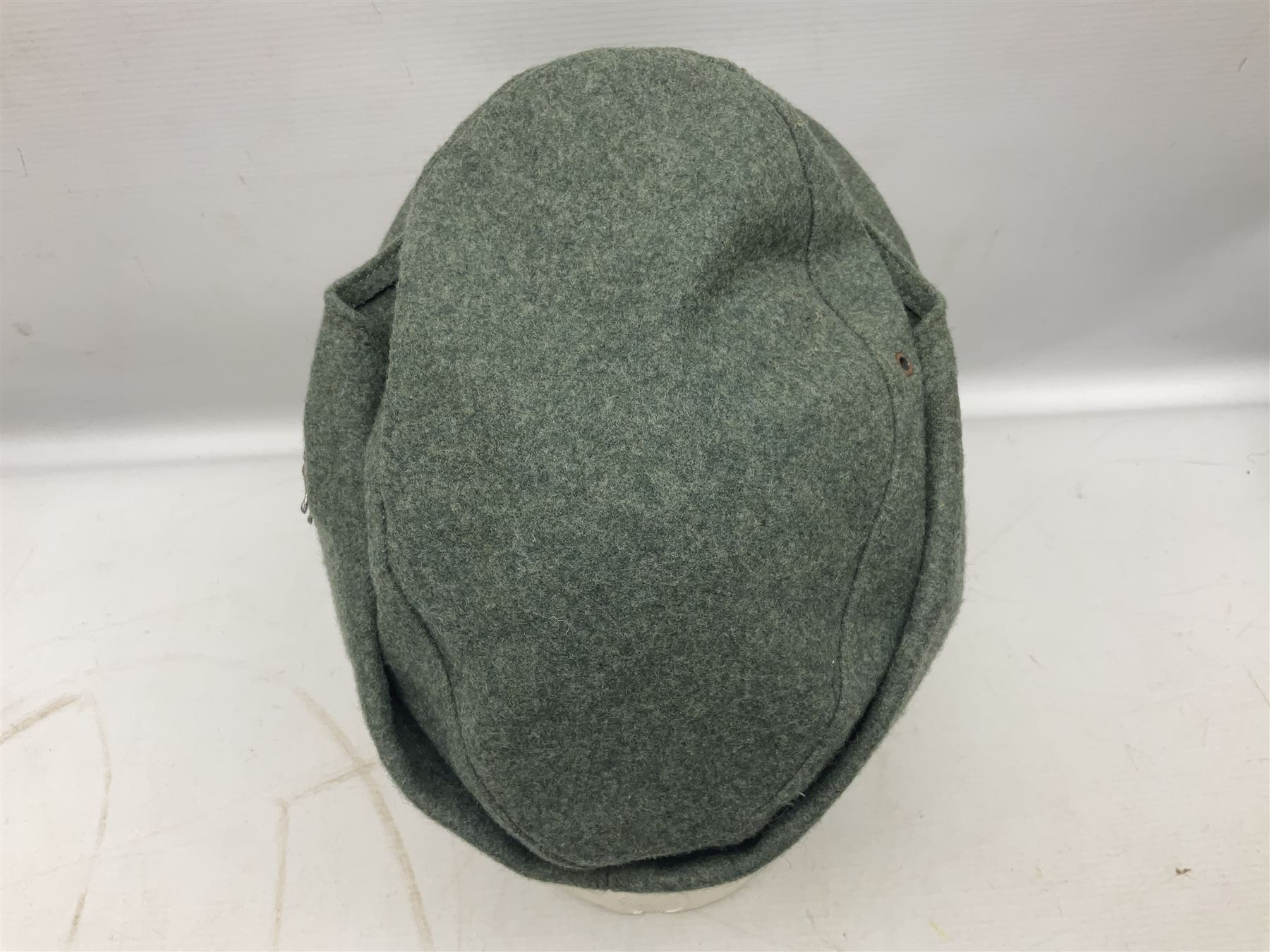 WW2 German Army M43 field cap with triangular cloth eagle and roundel badge and metal edelweiss badge for mountain troops; faintly stamped '5 VMF(?)'