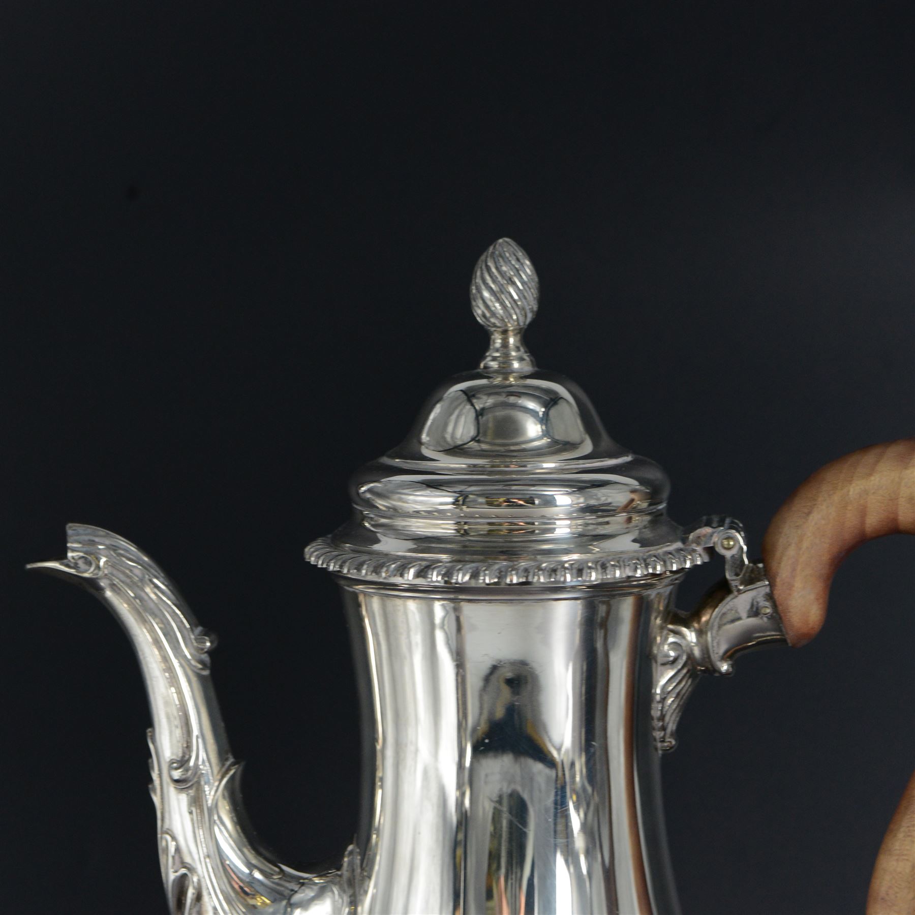 Modern three piece silver tea service, comprising coffee pot, teapot and milk jug, each of spherical form, upon circular domed foot, the teapot and coffee pot with wooden handles, the teapot with wooden finial, hallmarked Bryan Savage, London 1975, coffee pot H29cm