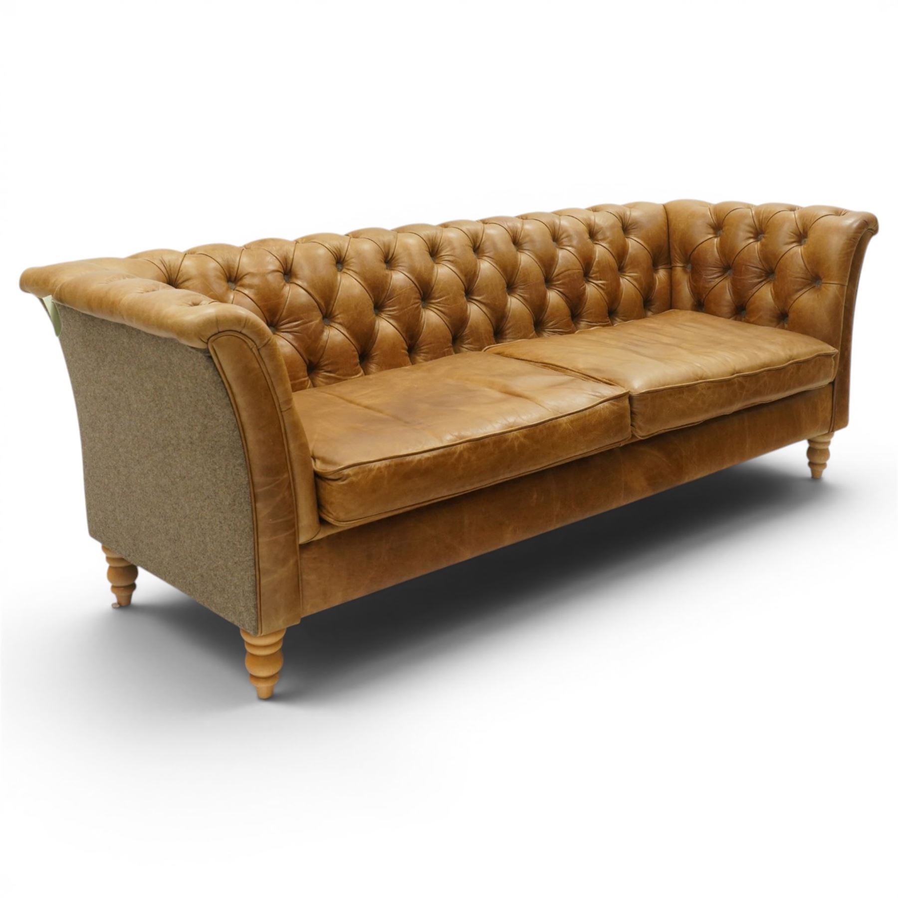 Contemporary Chesterfield design 'Caesar' three seat sofa, traditional shape with out-swept arms, upholstered in tan leather with loose seat cushions, the back, sides and buttons upholstered in chevron stitched Harris Tweed, on turned feet