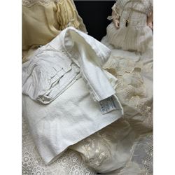 Two German bisque head dolls, to include a Franz Schmidt example with blue glass eyes and an Armand Marseille 590 example with applied hair, together with a Schoenau & Hoffmeister bisque doll's head, pair of doll's hands and a collection of clothing