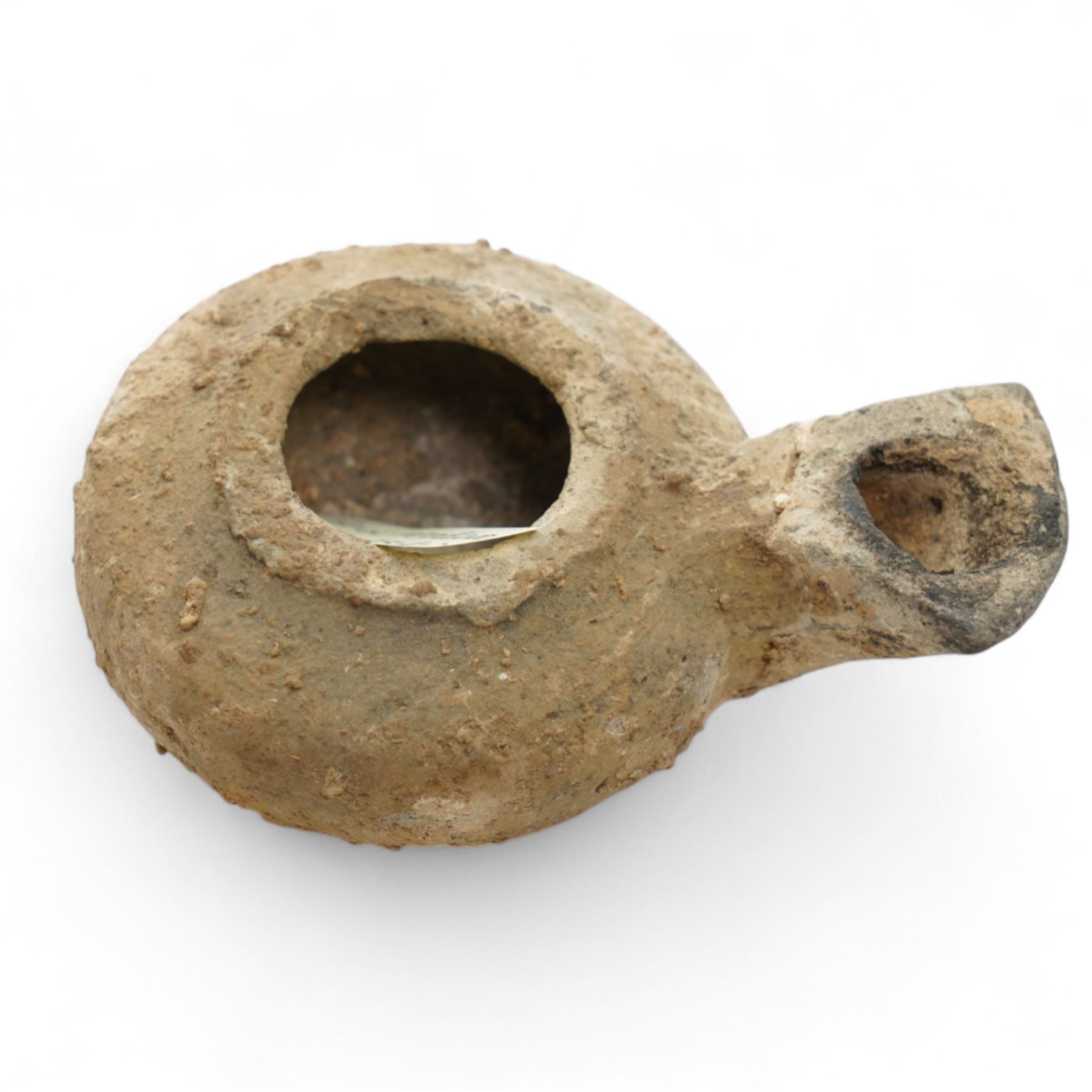 A group of five ancient terracotta oil lamps - Eastern Mediterranean (c.2nd century BC-1st century AD),
comprising a black-slipped Greek lamp (c.2nd-1st century BC) with a rounded body and narrow nozzle; a Herodian lamp (c.25 BC-75 AD) of compact form with central fill hole and pinched wick aperture; a Herodian lamp (c.1st century AD) with central raised disc and dotted ring motif; a Roman/Herodian hybrid lamp (c.50 BC-50 AD) with pronounced rounded shoulders and recessed top; and a further Roman/Herodian lamp (c.50 BC-50 AD) retaining an ancient carbonised wick fragment in the nozzle.
Provenance: By the vendor’s repute, acquired/collected in the Middle East (Dead Sea area/Syria) in the 1960s