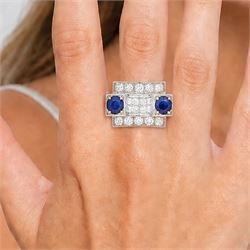 Platinum sapphire and diamond abstract design dress ring, pave set with eighteen old cut and round brilliant cut diamonds, with two mixed cut sapphires at each end, in a curved design setting, total sapphire weight approx 2.68 carat, total diamond weight approx 1.95 carat, with World Institute Report
