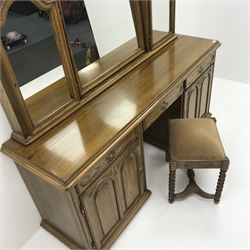 American oak twin pedestal dressing table, three piece mirror back above three drawers, two cupboards enclosing fitted interior, plinth base (W179cm, H161cm, D1cm) with stool 