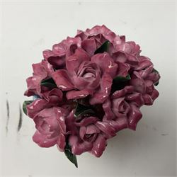 Halcyon Days bonbonniere, modelled as pink roses in a planter painted with a blue and white Japanese scene, together with five Halcyon Days enamel boxes, one a larger example depicting 'The Becket Casket' and four smaller boxes, including The 1993 Easter Egg, Happy Birthday and Statue of Liberty examples, all boxed, Becket Casket D8cm