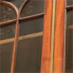 Early 19th century mahogany secretaire-bookcase, projecting cornice above astragal glazed cabinet with adjustable shelved interior, fall front secretaire drawer, fitted interior with pigeonholes and drawers, flame mahogany fronted cabinet with three drawers, on turned supports 