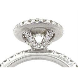 De Beers Aura platinum round brilliant diamond ring, the central diamond solitaire of 1.07 carat, clarity VVS2, colour E, with GIA certificate, surrounded by halo of diamonds and diamond set shoulders, total diamond weight 1.46 carat boxed with authenticity card and purchase receipt dated 2017