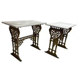 Pair of 19th century cast iron entrance tables, rectangular marble top over ornate gilt bases with scrolling foliate design and sledge feet, united by balustrade stretcher with scroll spandrels