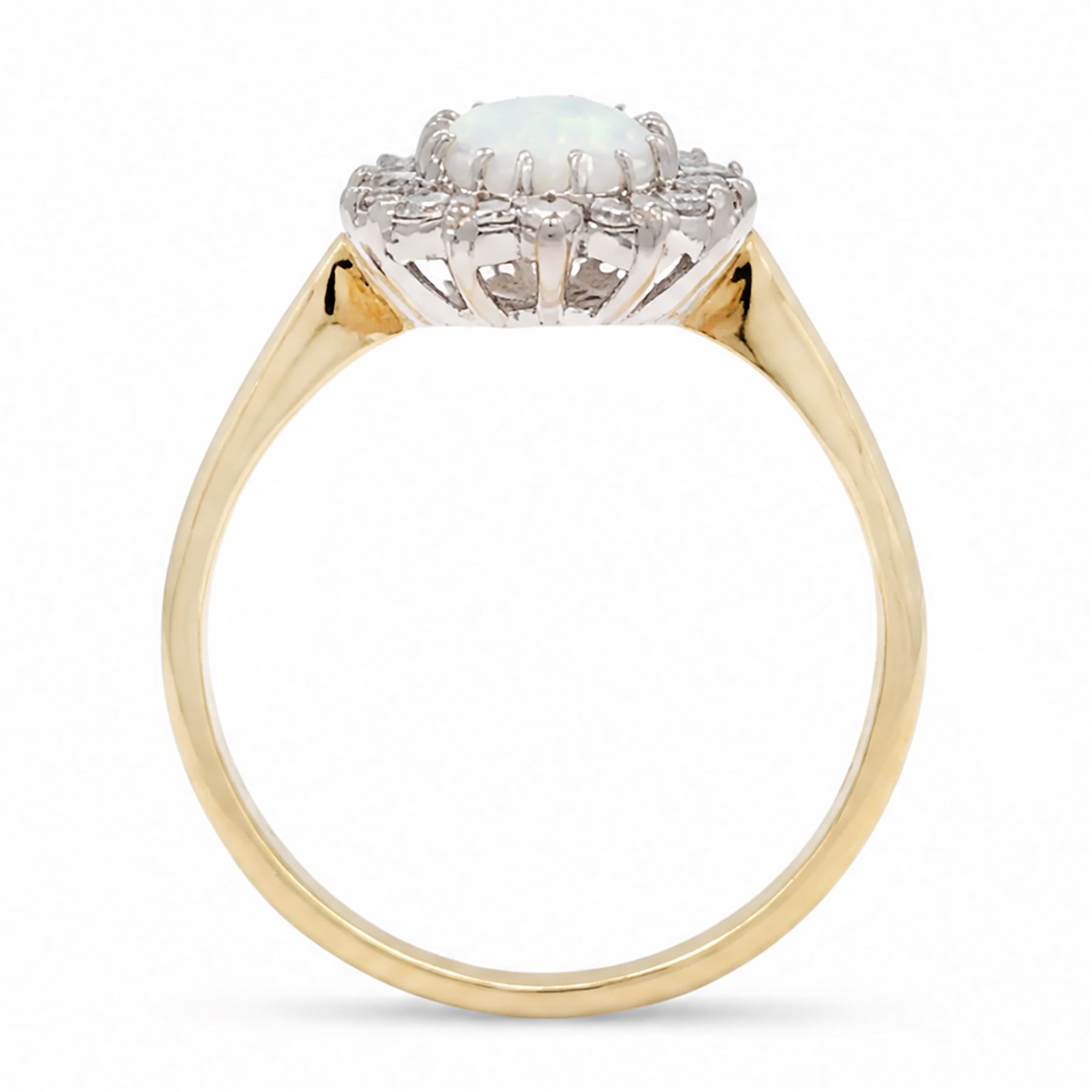 18ct gold opal and diamond cluster ring, single oval cabochon cut opal, surrounded by fourteen round brilliant cut diamonds, London 1988, total diamond weight approx 0.30 carat