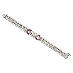 Art Deco platinum diamond and ruby bracelet, circa 1920-1930, the central panel set with a single emerald cut diamond of approx 0.55 carat, flanked by two baguette cut diamonds and old cut diamond surround, the articulated geometric design bracelet with vari-cut rubies, round and baguette cut diamonds, total diamond weight approx 7.00 carat, in Mappin & Webb silk and velvet lined box