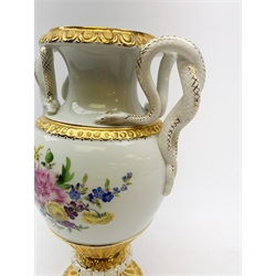  A Meissen twin handled vase, of baluster form with waisted neck, serpent modelled handles, and raised upon a spreading circular foot, hand painted with floral sprays and heightened with gilt, with crossed swords mark beneath, H26.5cm.  