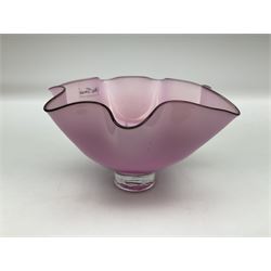 Gillies Jones pink glass bowl with crimped black rim upon a pedestal foot, H11cm