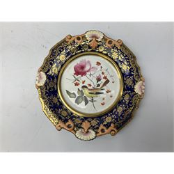 Group of 19th Century and later plates comprising James and Ralph Clews pearlware example from the Dr Syntax Series entitled 'Doctor Syntax disputing his Bill with his Landlady', D26cm, along with a  hand painted plate decorated with birds amongst blossoming branches in a central circular panel surrounded by gilt and cobalt blue foliate border, possibly Hicks Meigh, and a Wedgwood example decorated with lake scene (3)