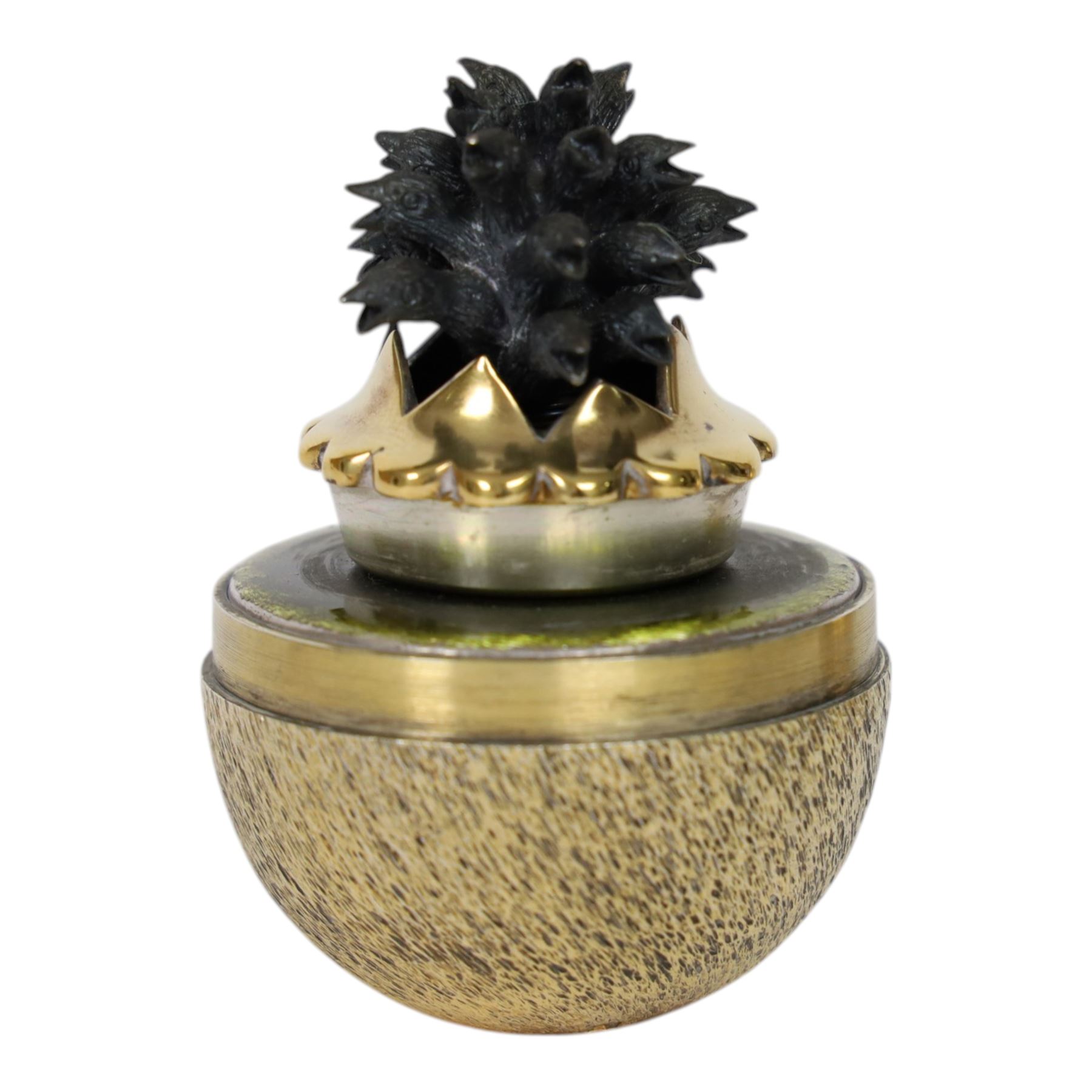 Late 20th century silver and silver-gilt surprise egg, the textured gilt exterior opening to reveal a clutch of chicks, the clustered heads supported upon a spring, within a jagged and lobed silver and gilt encasement, with green enamel surround, hallmarked Stuart Devlin, London 1982, H7cm