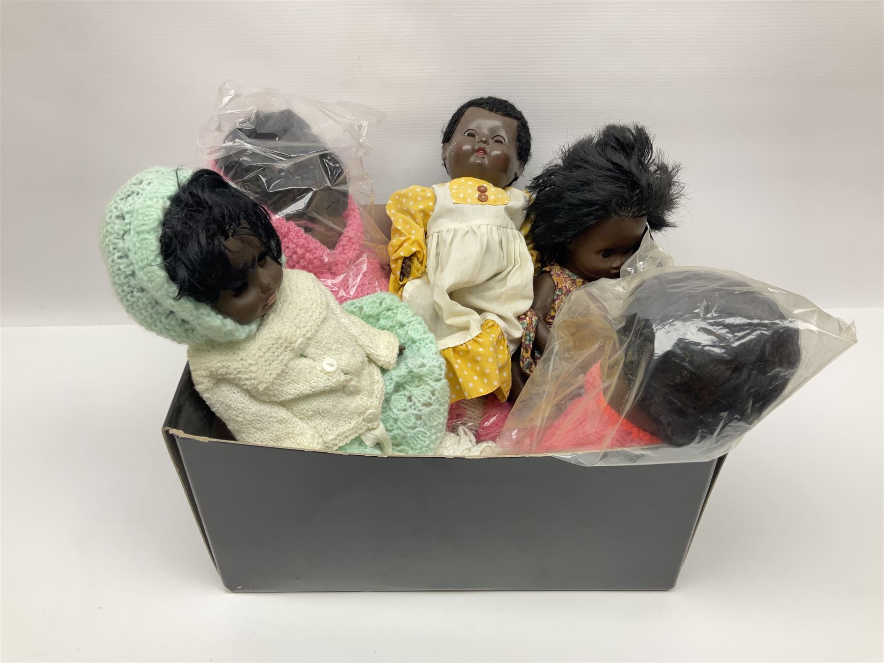 Quantity of vintage and later dolls to include unusual three faced example and further dolls marked C.J, Gloobee, Rosebud etc in three boxes