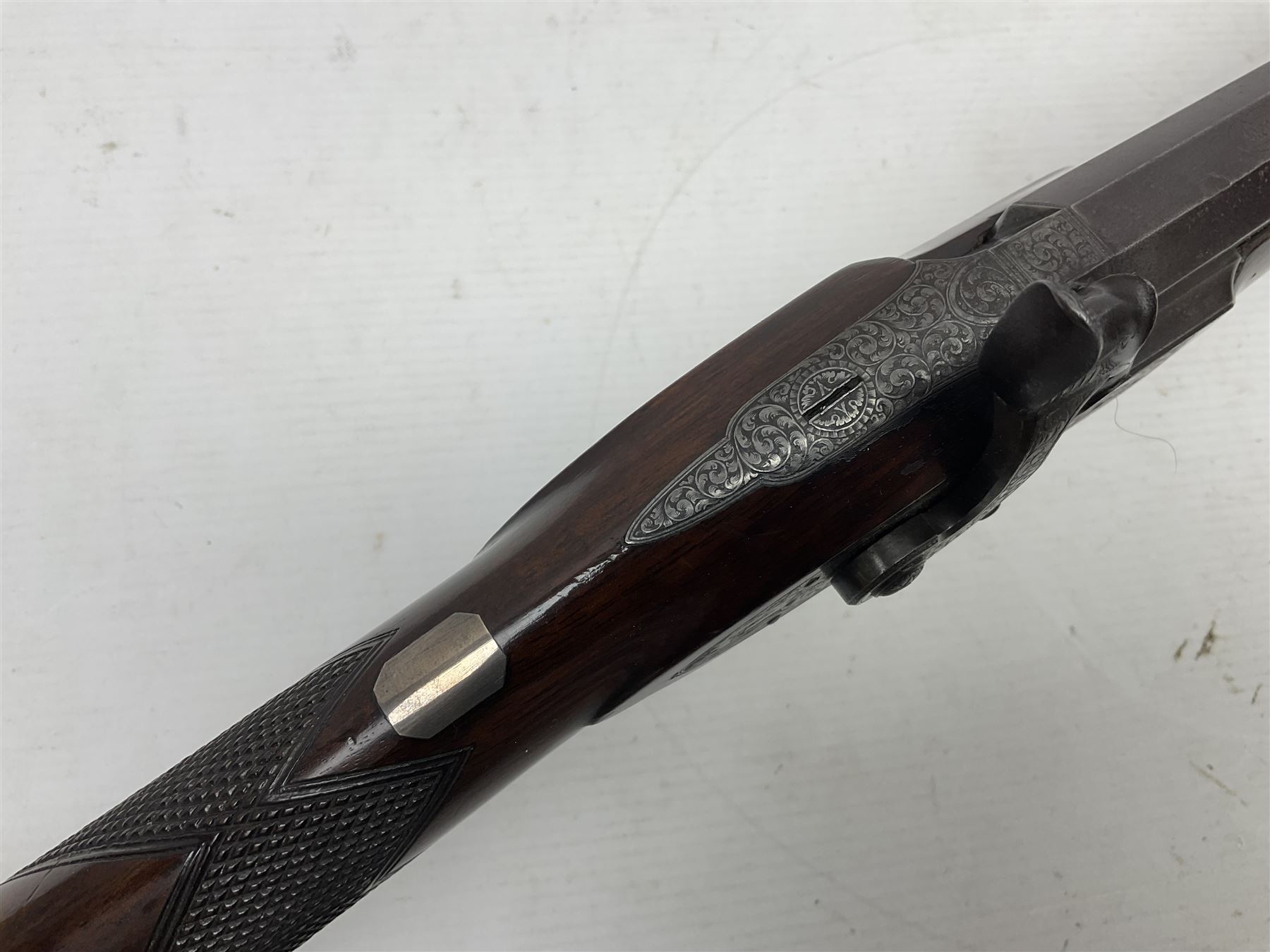 Mid-19th century percussion rifle by Geo. Forrest & Sons of Jedburgh No.844, 79cm octagonal barrel (approx .45 bore) with folding foresight, the lock plate with dolphin hammer finely engraved with a tiger and a stag, trigger guard engraved with hounds chasing a stag, figured walnut half stock with chequered grip and original ramrod 121cm overall; with framed photograph of original owner Dr. A.B. Dresser and archive of related ephemera including manuscript letter from the makers to Dr. Dresser regarding the sight specifications.