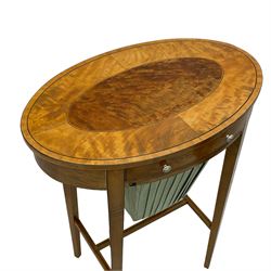 Edwardian inlaid satinwood work or sewing table, oval top with figured central inlay, fitted with a single drawer with bone handles, over a basket well covered with pale blue pleated fabric, raised on square tapering supports united by H-stretcher and ebony stringing single drawer with basket well